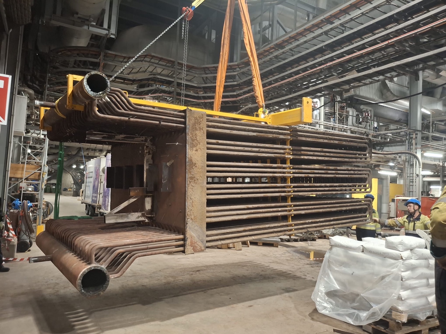 Large boiler pressure-part assembly being positioned during industrial installation work